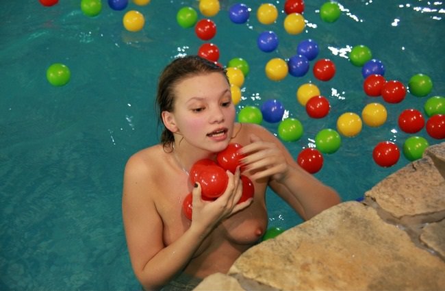 Naturists group of family and friends in the water park photo